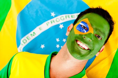 Happy man with the Brazilian flag painted on his face