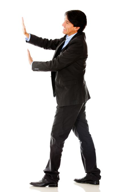 Business man pushing something with his hands - isolated over a white background