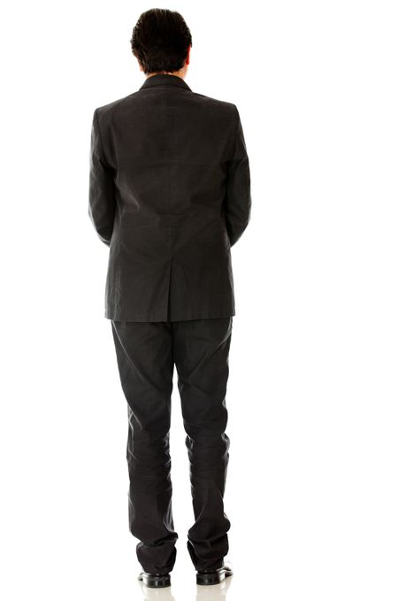 Rear view of a businessman in a suit - isolated over a white background