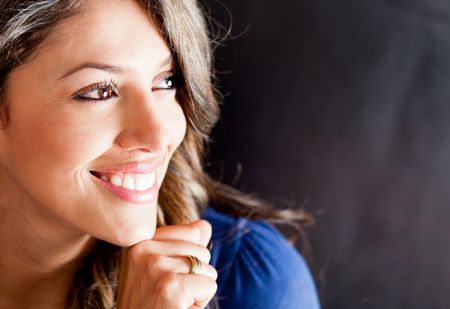 Happy woman portrait - isolated over a black background