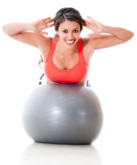 Woman exercising with pilates ball - isolated ove a white background